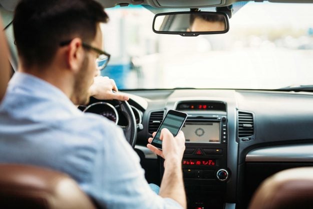 Man texting o phone while driving