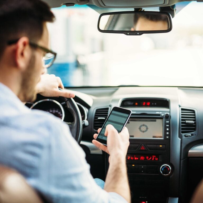 Distracted Man texting o phone while driving