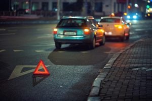 Two cars parked on the side of the road.