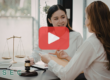 Two women in a meeting on a lawyers office. Red play buttom overlay and SEC logo.