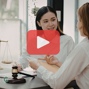 Personal injury lawyer meeting Two women in a meeting on a lawyers office. Red play buttom overlay and SEC logo.