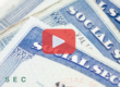Close up of social security cards. Red play buttom and SEC logo.