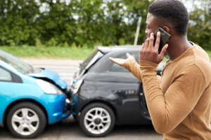 Man making phone call after car crash.