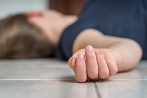 Woman laying on floor passed out.