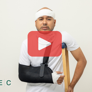 Man with arm in a cast and crutch. Red play buttom and SEC logo.