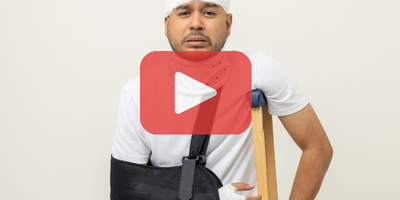 Man with arm in a cast and crutch. Red play buttom and SEC logo.