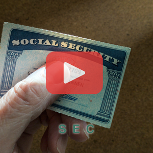 SS card Person holding social security card. Red play buttom overlay and SEC logo.
