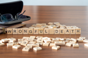 Scrabble tiles spelling words: Wrongful death, on wooden table